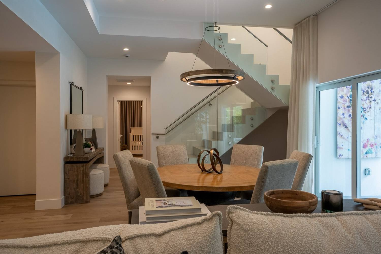 The finished custom stair in Pinecrest over the dining room, ring pendant above