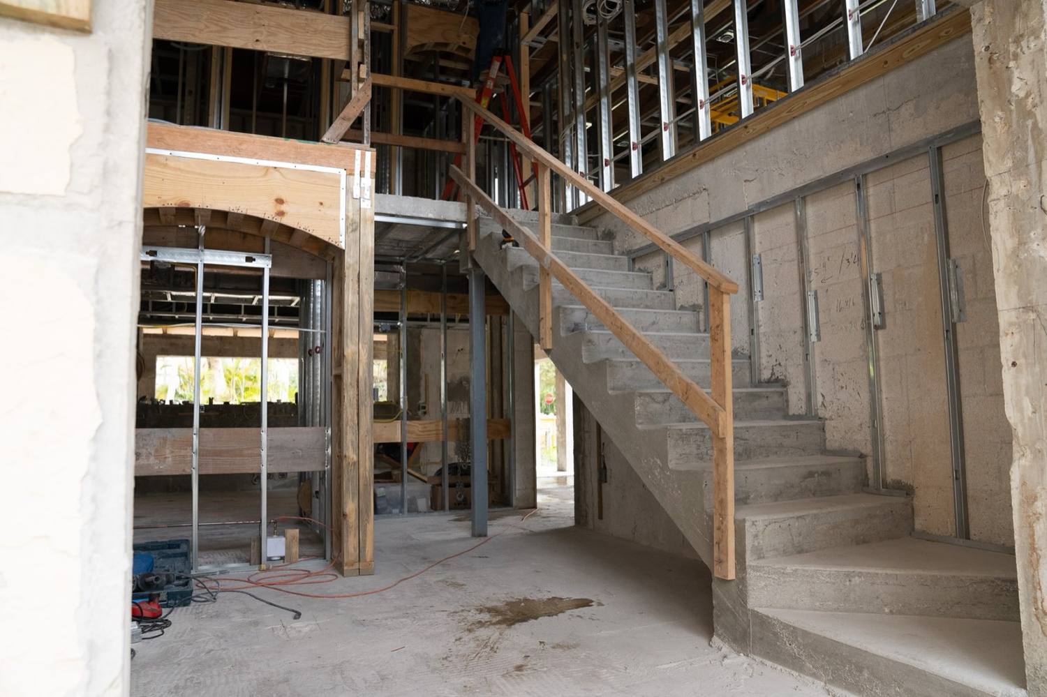The stair of the Coral Gables historic district house during construction, concrete with a temporary rail