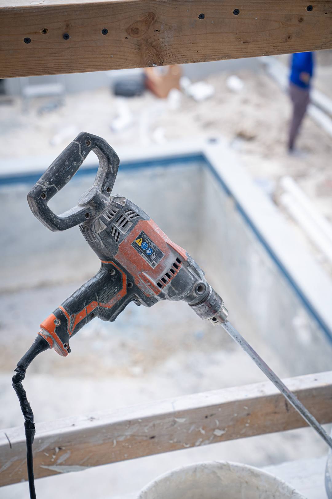 A drill resting on a window sill during a build