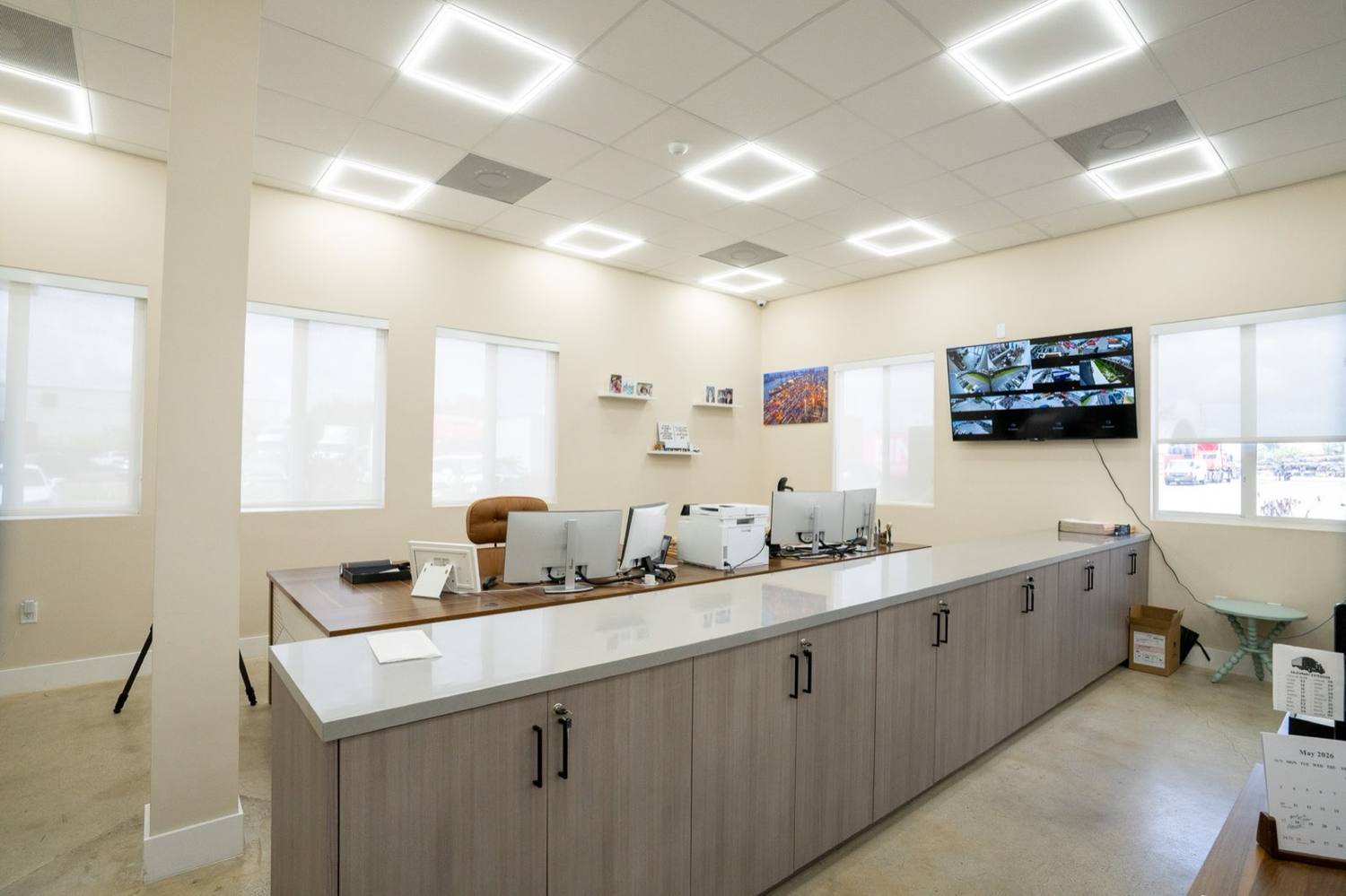 The finished break room inside the Opa-locka office building, grey cabinetry and counters under the windows