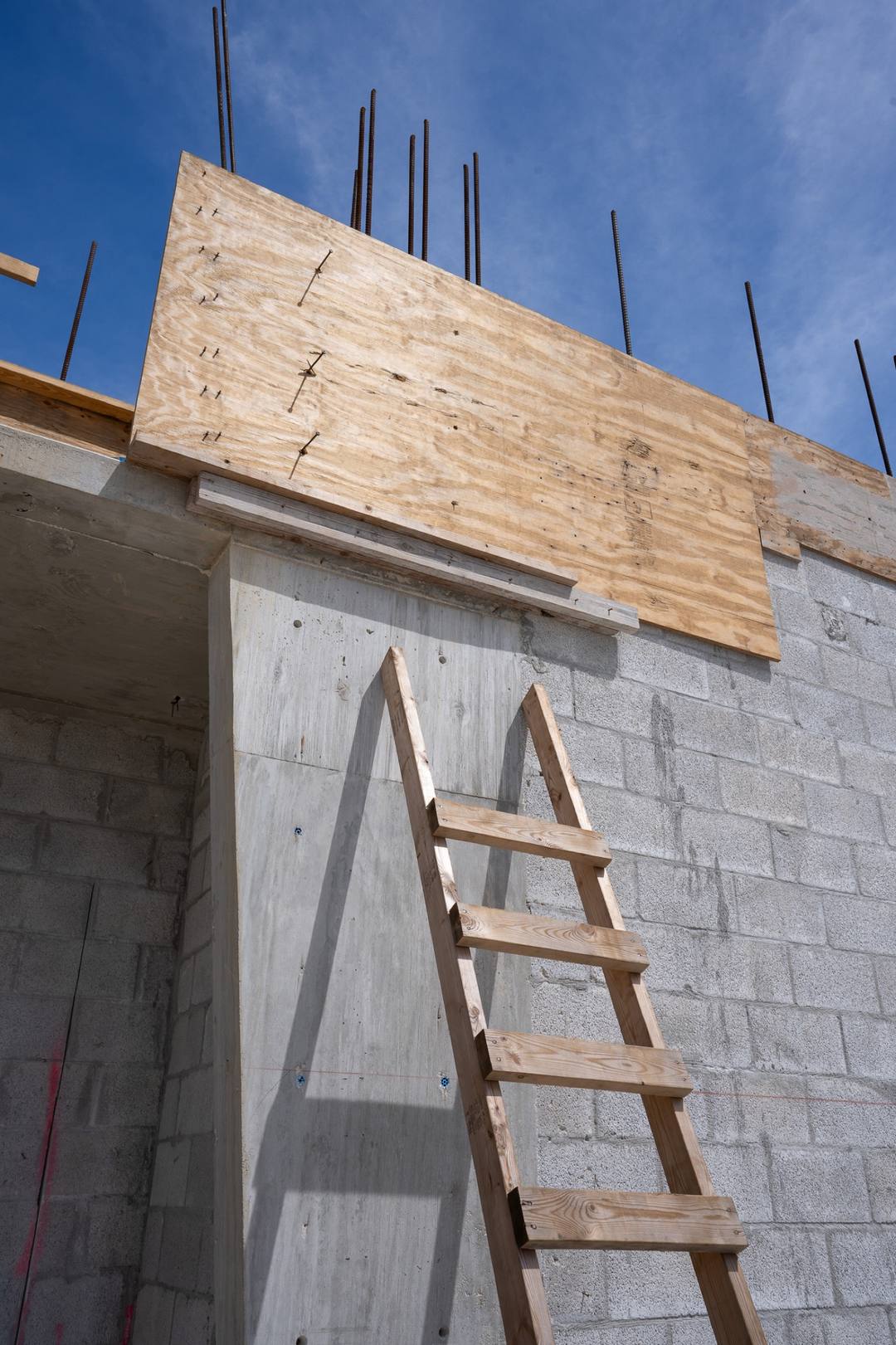 Formwork and a ladder against a concrete block wall