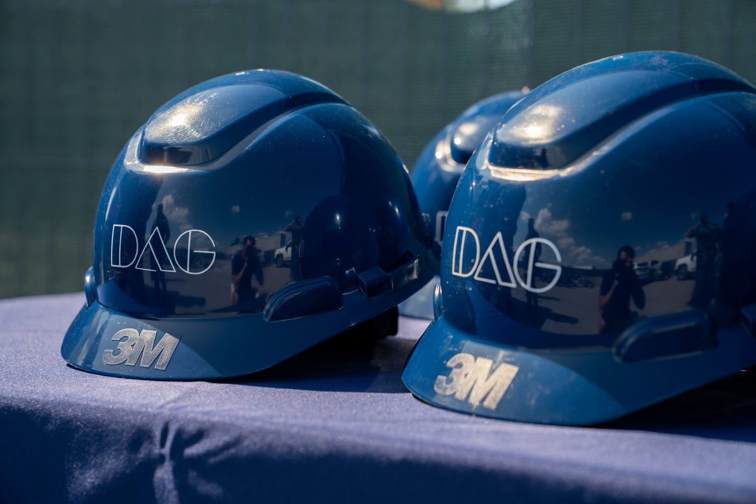 DAG hardhats arranged on the groundbreaking table before the ceremony