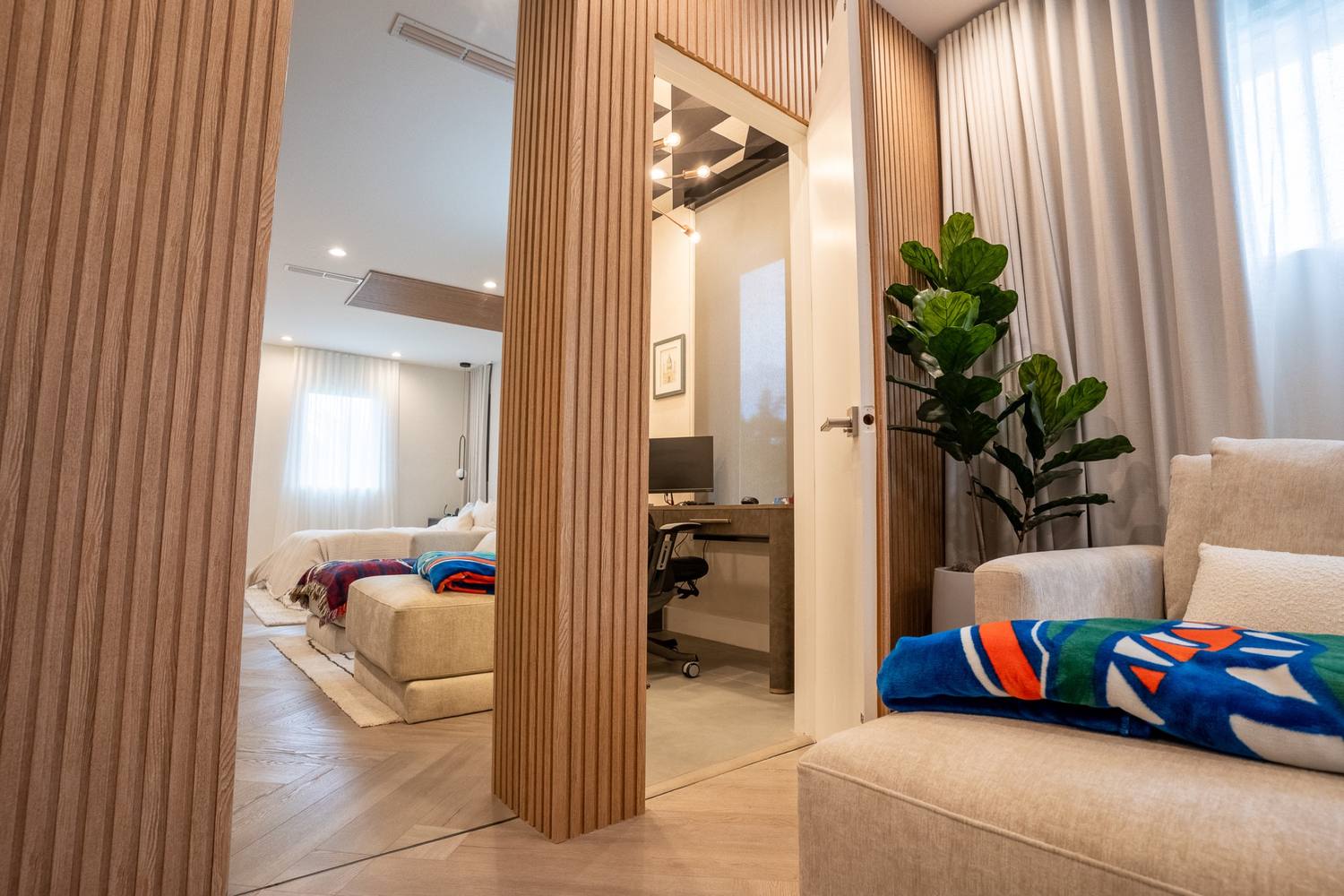 Hallway lined in oak slats leading to the bedrooms