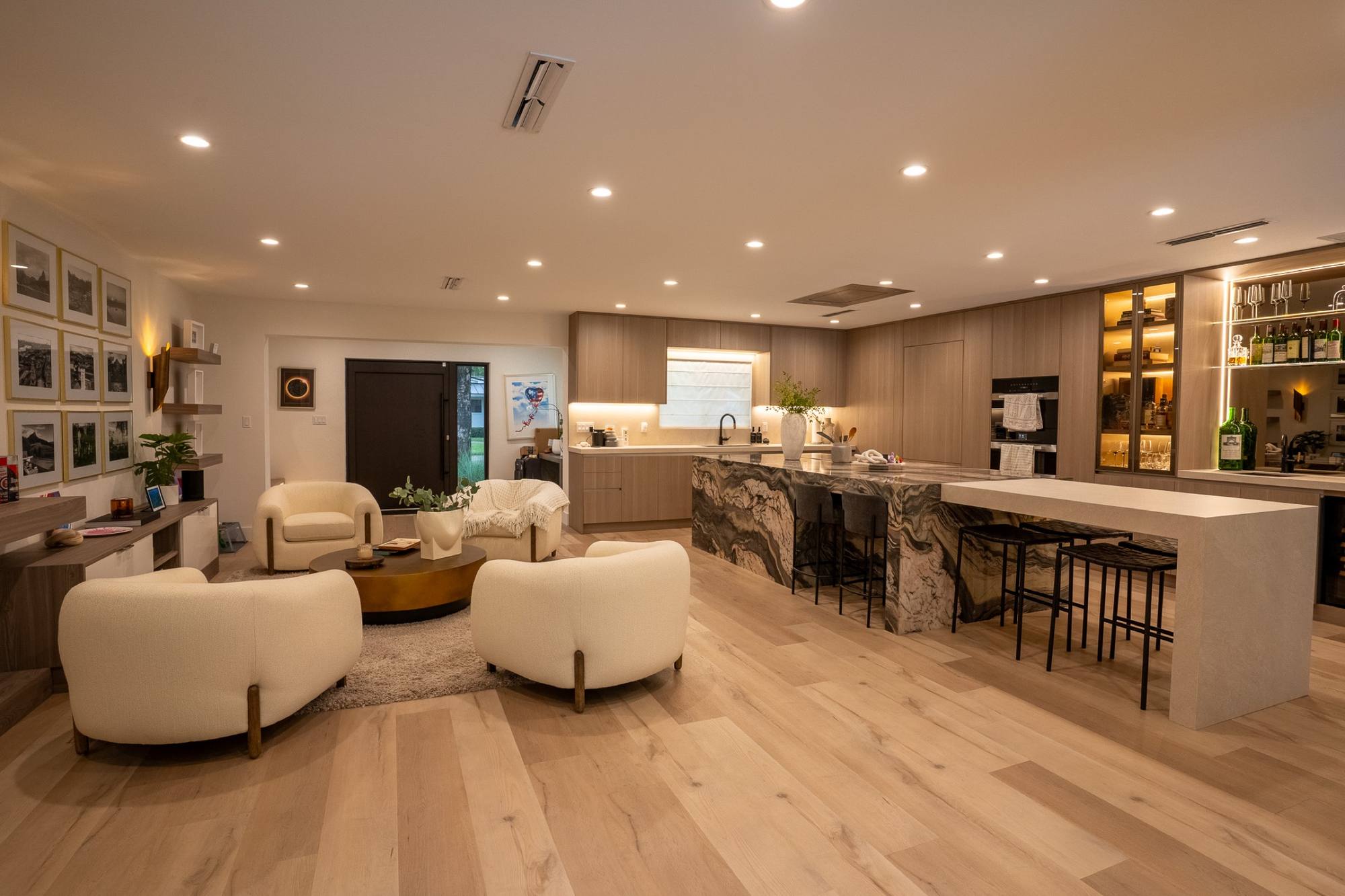 A finished living room and bar in a Pinecrest home, evening light