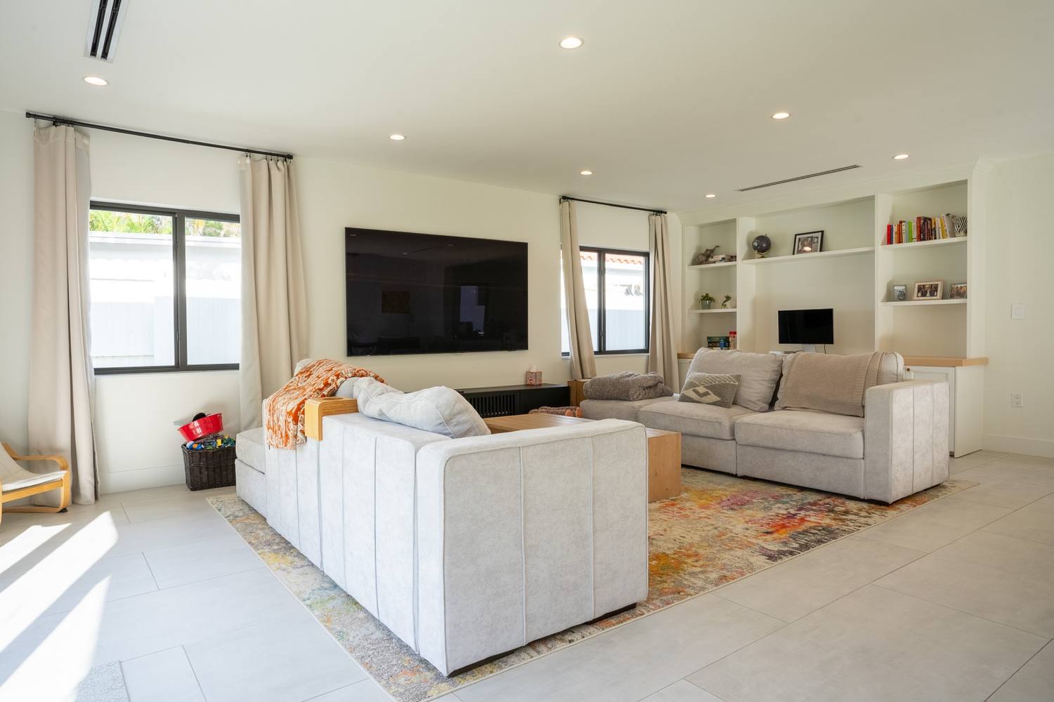 Living room with a white sofa and built-in shelves